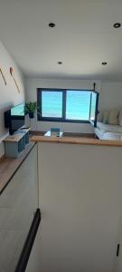 a room with a bed and a large window at BURELA Mariña PLAYA in Burela de Cabo