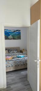 a bedroom with a bed and a painting on the wall at Stan na dan BB 2 in Bajina Bašta