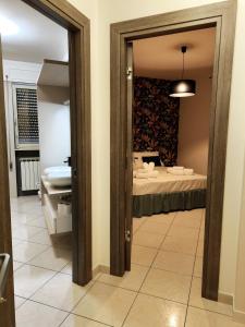 a room with a bed and a bathroom with a mirror at Petra in Pietrelcina