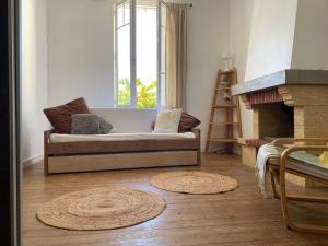 a living room with a couch and a fireplace at Brise des dunes in Saint-Pierre-dʼOléron
