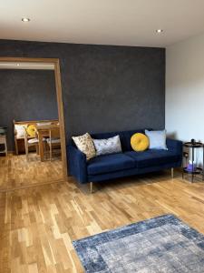 a blue couch in a living room with a table at The Sidings, Wool in Wareham