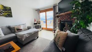 a living room with a couch and a fireplace at Mountains Getaway in Campton