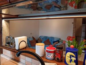 a kitchen counter with a table with a couch in the background at Rustico al mare in Ladispoli