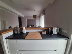 a kitchen with a black counter top with a microwave at Le case di Lucanna in Rapallo