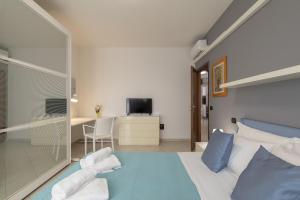 Un dormitorio con una cama, un escritorio y un televisor. en Easy Venice - Flat in Mestre, en Venecia