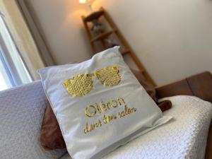 a pillow with a bow tie and glasses on it at Brise des dunes in Saint-Pierre-dʼOléron