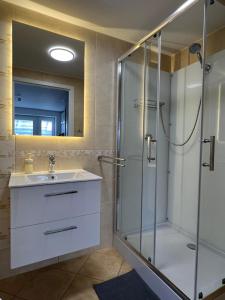 a bathroom with a shower and a sink at Pokoje Gościnne REST in Karwia +23 photos