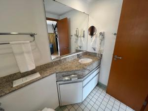 a bathroom with a sink and a mirror at Hotel Live Logde Ibirapuera UH-904 in Sao Paulo