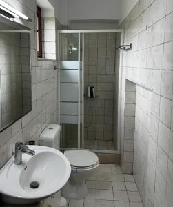 a bathroom with a toilet and a sink and a shower at One&Only Kalamoti Gem Retreat in Kalamoti