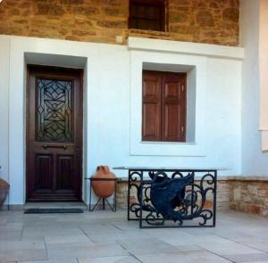 a bench in front of a house with a door at One&Only Kalamoti Gem Retreat in Kalamoti +13 photos
