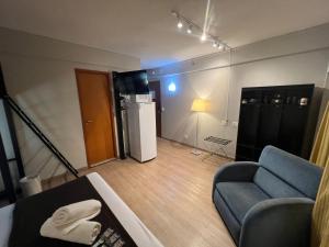 a living room with a couch and a table at Hotel Live Logde Ibirapuera UH-904 in Sao Paulo