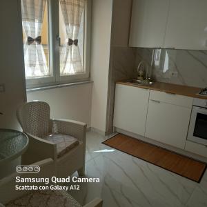 a kitchen with a table and a chair and a window at Jenny's house in Castellammare di Stabia