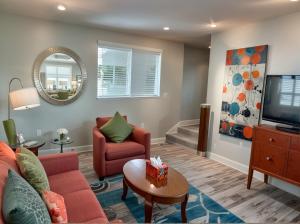 a living room with a couch and a tv at Hollywood Homes Free parking close to all things LA in Los Angeles +68 photos