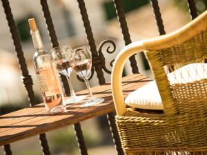 a table with two glasses and a bottle of wine at Hotel Cala Sant Vicenç - Adults Only in Cala de Sant Vicenc