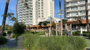 a playground in front of a large apartment building at Porta Mare - Dziwnówek - Ferienappartment an der polnischen Ostsee in Dziwnówek