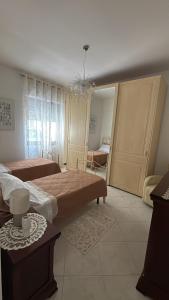 Ένα ή περισσότερα κρεβάτια σε δωμάτιο στο Casa vacanze Amabile +3 φωτογραφίες