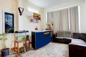 a living room with a fish tank and a couch at Paradise Living in Bangalore
