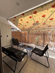 a room with chairs and a flower mural on the ceiling at Georges House in Nea Moudania