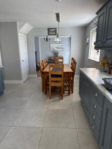a kitchen with a dining room table and chairs at Pear Tree Cottage, Portstewart in Portstewart