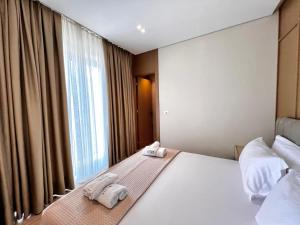Postel nebo postele na pokoji v ubytování Avenue Hotel