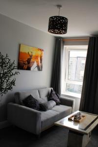 a living room with a couch and a table at Stylish Apartment in Tralee in Tralee