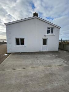 a large white building with a parking lot at Anchor’s Away in Letterkenny +18 photos