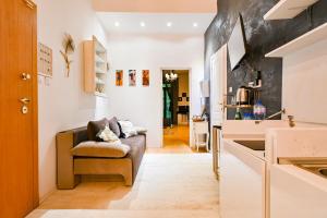 a living room with a couch and a kitchen at Luxory in Sofia