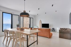 a dining room with a table and chairs at El Submarino Coastal Home in Santa Maria de Guia de Gran Canaria