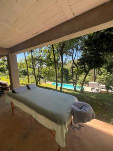 a bed in a room with a view of a pool at Shalpabay - Rooms in Taquillo