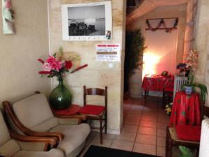 uma sala de estar com cadeiras e um vaso de flores em Hotel Du Parc em Bordéus