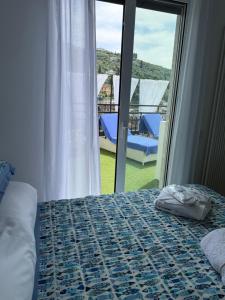 a bedroom with a bed and a view of a balcony at Appartamento Rapallo Sky Garden Maria Jose Liguria - Attico vista mare - Terraces - 2 bagni- 2 Camera da Letto - Box, Wi-fi, Idromassaggio Free inteiro Attico per Voi, con Ascensore in Rapallo +68 photos