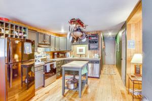 a kitchen with wooden floors and stainless steel appliances at 1 Mi to Lake Easton Cozy Cascades Cabin! in Cabin Creek