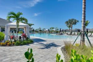 a pool at the resort with a gazebo and palm trees at Golf, Swim, Shop and More Luxury Retreat in Naples! in Naples