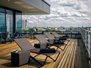 a balcony with chairs and tables on a building at Vienna House by Wyndham Andel's Berlin in Berlin