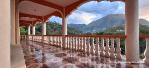 a balcony of a house with a view of the mountains at La Estancia in Lanquín