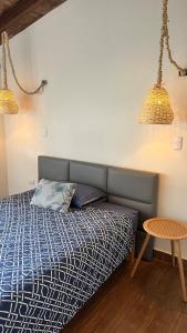 a bed in a room with two lamps and a table at Accommodation in Huaral in Huaral