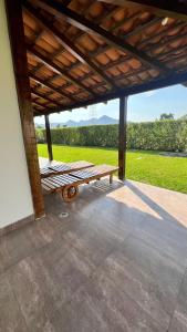 a porch with a wooden bench under a roof at Accommodation in Huaral in Huaral