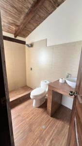 a bathroom with a toilet and a sink at Accommodation in Huaral in Huaral