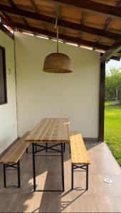 a picnic table and two benches sitting under a roof at Accommodation in Huaral in Huaral +8 photos