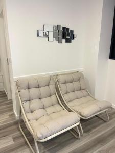 a couch and a chair in a room at Casa PEREIRA 4 in Ponta do Pargo +1 photo