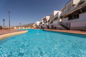 a swimming pool in front of a building at Mosaico Ocean View Boutique Apartment in Adeje