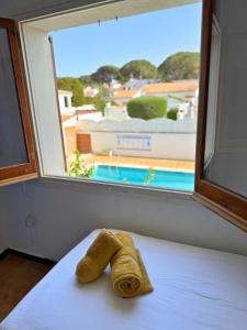 a towel sitting on a bed in front of a window at Casa Blava L'Escala B&Q Pool&Tennis Terrace in L'Escala