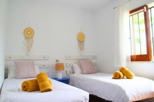 two beds with towels on them in a bedroom at Casa Blava L'Escala B&Q Pool&Tennis Terrace in L'Escala