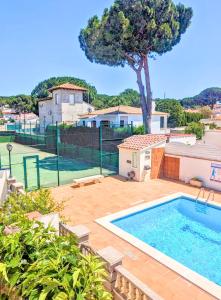 a swimming pool in the backyard of a house at Casa Blava L'Escala B&Q Pool&Tennis Terrace in L'Escala