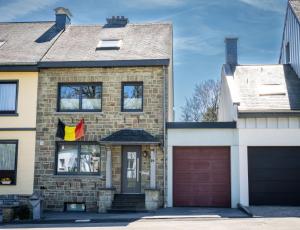 a house with a flag hanging in the window at Haus Wanderlust in Saint-Vith
