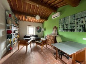 a living room with green walls and a table at Podere Buriano, Villa with Swimmingpool in Monterotondo