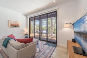 a living room with a couch and a large window at Stunning Modern Mountain Home for 10 in Truckee New Hot Tub BBQ Close to Slopes Book on Mobile for Promo Price in Truckee
