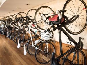 a row of bikes lined up against a wall at Hotel Cala Sant Vicenç - Adults Only in Cala de Sant Vicenc