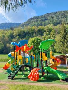 a playground with a bunch of slides in a park at Philia Dolomiti, Folgarida in Folgarida