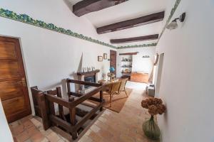 a living room with a staircase and a table and chairs at La Casetta di Zio Gino in Cingoli